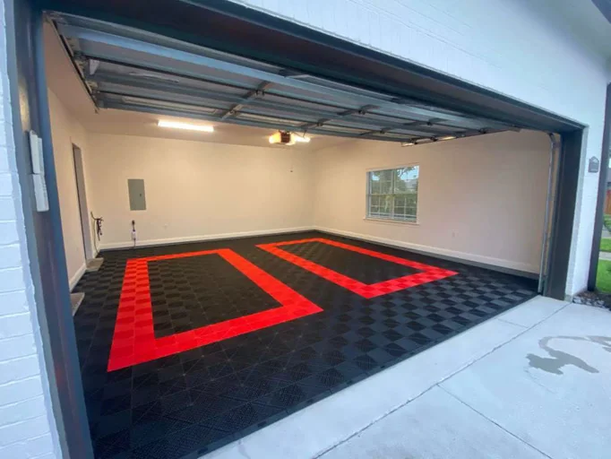 Double garage with black tile floor and two red parking bays