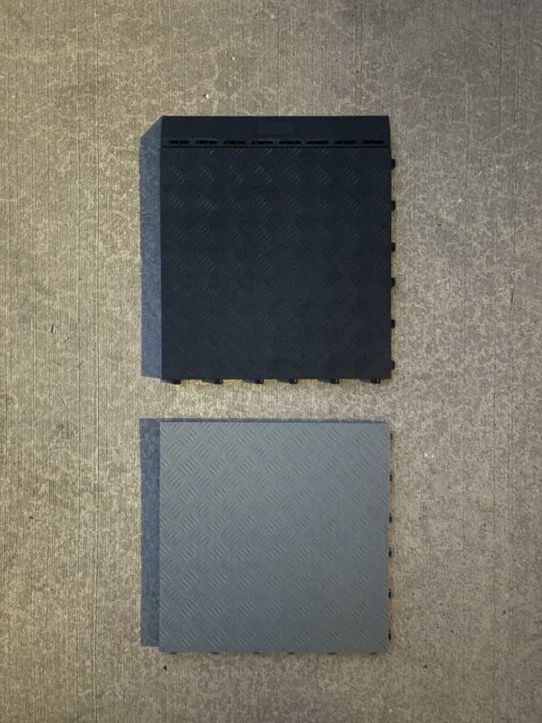 Black and grey solid garage tiles with a raised tread pattern